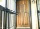 Inviting front door with a security screen showcasing a unique carved design and traditional lantern style lighting at 1927 E Hampton Ave # 260, Mesa, AZ 85204