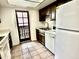 The kitchen has a stainless sink, dishwasher and refrigerator and access to the outside through a door at 1927 E Hampton Ave # 260, Mesa, AZ 85204