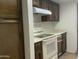 Well-organized kitchen with white appliances, a sleek range hood, and wood cabinets at 1927 E Hampton Ave # 260, Mesa, AZ 85204