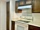 Well-lit kitchen featuring plenty of cabinet space and a smooth cooktop. Perfect for cooking and storage at 1927 E Hampton Ave # 260, Mesa, AZ 85204