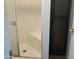 Bathroom featuring a tiled shower with a glass door and a built-in seat at 1927 E Hampton Ave # 260, Mesa, AZ 85204