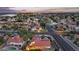 An aerial shot displaying a home with solar panels and a backyard pool, set within a lively neighborhood at 1940 E Citation Ln, Tempe, AZ 85284