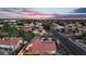 An aerial view captures a well-manicured neighborhood and home with solar panels and an inviting backyard pool at 1940 E Citation Ln, Tempe, AZ 85284