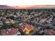 Expansive aerial view showing a home with a pool and a patio, nestled in a verdant neighborhood at dusk at 1940 E Citation Ln, Tempe, AZ 85284
