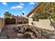 Backyard pond and bridge surrounded by lush landscaping, fruit trees and privacy walls at 1940 E Citation Ln, Tempe, AZ 85284