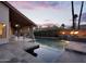 Outdoor living space featuring a pool with fire bowls, covered patio, and lush landscaping for ultimate relaxation at 1940 E Citation Ln, Tempe, AZ 85284