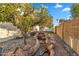 Charming backyard with a unique rock water feature, lush foliage, and vibrant orange trees at 1940 E Citation Ln, Tempe, AZ 85284