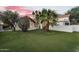 The verdant backyard features artificial grass and desert landscaping for easy maintenance and beauty at 1940 E Citation Ln, Tempe, AZ 85284