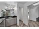 Elegant bathroom with gray cabinets, granite counters, decorative lights, and soaking tub in background at 1940 E Citation Ln, Tempe, AZ 85284