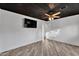 Bedroom with a ceiling fan, mounted tv and light wood look flooring at 1940 E Citation Ln, Tempe, AZ 85284
