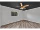 Bedroom features wood flooring, ceiling fan, and a dark ceiling at 1940 E Citation Ln, Tempe, AZ 85284