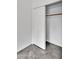 Bedroom closet with white sliding doors and gray tile flooring at 1940 E Citation Ln, Tempe, AZ 85284