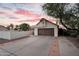 Traditional home featuring a two-car garage, a private courtyard, and a desert-style landscape at 1940 E Citation Ln, Tempe, AZ 85284