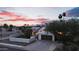 Charming one-story home with a well-kept yard, palm trees, and a two car garage at sunset at 1940 E Citation Ln, Tempe, AZ 85284
