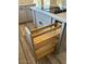Kitchen cabinets featuring a wooden pull-out with stainless steel rods at 1940 E Citation Ln, Tempe, AZ 85284