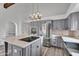 An eat-in kitchen with gray cabinets, stainless steel appliances, and a large center island at 1940 E Citation Ln, Tempe, AZ 85284