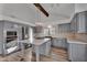 An eat-in kitchen with gray cabinets, stainless steel appliances, and a large center island at 1940 E Citation Ln, Tempe, AZ 85284