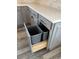 Gray kitchen cabinets offer convenient pull-out trash bins and a modern design at 1940 E Citation Ln, Tempe, AZ 85284