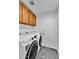 This laundry room has a washer and dryer and wooden cabinets at 1940 E Citation Ln, Tempe, AZ 85284