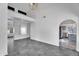 Open-concept living room with high ceilings, neutral paint, and tile floors connecting to the kitchen at 1940 E Citation Ln, Tempe, AZ 85284