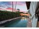 Outdoor oasis with a stunning pool, fire bowls, palm trees, and a covered patio for entertaining at 1940 E Citation Ln, Tempe, AZ 85284