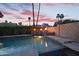 Tranquil pool featuring fire bowls cascading water, lush landscaping, and offering a serene backyard escape at 1940 E Citation Ln, Tempe, AZ 85284
