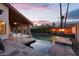 A luxurious pool with cascading waterfalls, fire bowls, and covered patio for relaxing evenings outdoors at 1940 E Citation Ln, Tempe, AZ 85284