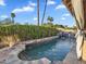 Backyard pool with lush tropical landscaping and stone accents at 1940 E Citation Ln, Tempe, AZ 85284
