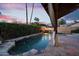 Backyard pool featuring fire bowls, lush greenery, and a covered patio perfect for evening relaxation at 1940 E Citation Ln, Tempe, AZ 85284