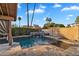 Backyard swimming pool with stone tile patio, waterfall feature and covered patio at 1940 E Citation Ln, Tempe, AZ 85284