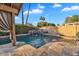Backyard swimming pool with stone tile patio, waterfall feature and covered patio at 1940 E Citation Ln, Tempe, AZ 85284