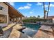 Backyard with swimming pool, covered patio, stone tile and manicured landscaping at 1940 E Citation Ln, Tempe, AZ 85284