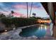 Backyard pool featuring stone features and a dramatic fire pit for an opulent entertaining experience at 1940 E Citation Ln, Tempe, AZ 85284