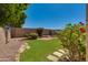 The backyard features a grassy lawn, mature trees, and brick border surrounding garden at 19851 N 35Th St, Phoenix, AZ 85050
