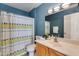 Bathroom boasts a double vanity, stylish decor, and patterned shower curtain at 19851 N 35Th St, Phoenix, AZ 85050