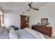 Bedroom features a ceiling fan and a wooden sliding barn door to the bathroom at 19851 N 35Th St, Phoenix, AZ 85050