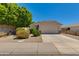 Charming single-story home featuring a two-car garage, a well-manicured lawn, and mature trees at 19851 N 35Th St, Phoenix, AZ 85050