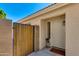 Inviting front entrance with a decorative security door, desert landscaping, and secure courtyard gate at 19851 N 35Th St, Phoenix, AZ 85050