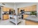 Well-equipped kitchen with stainless steel appliances, wood cabinets, and an island with breakfast bar at 19851 N 35Th St, Phoenix, AZ 85050