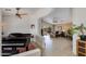 Open-concept living room with tile flooring, ceiling fan, and sliding glass doors to the backyard at 19851 N 35Th St, Phoenix, AZ 85050