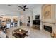 Open living area with fireplace, adjacent kitchen, tile floors, and ample natural light at 19851 N 35Th St, Phoenix, AZ 85050