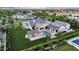 Aesthetic backyard featuring a modern home, sparkling pool, outdoor kitchen, and pristine lawn at 20649 E Vallejo Ct, Queen Creek, AZ 85142