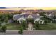 Luxury home showcasing lush landscaping, mature trees, and an inviting brick pathway to the front entrance at 20649 E Vallejo Ct, Queen Creek, AZ 85142