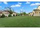 Spacious backyard featuring an expansive lawn area and perimeter fencing at 20649 E Vallejo Ct, Queen Creek, AZ 85142