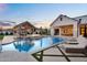 Resort-style backyard with pool, spa, fire feature, and covered patio at 20649 E Vallejo Ct, Queen Creek, AZ 85142