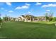 Expansive backyard with lush green lawn and luxurious outdoor living spaces, perfect for entertaining and recreation at 20649 E Vallejo Ct, Queen Creek, AZ 85142