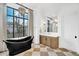This luxurious bathroom features a soaking tub, vanity with a marble countertop, and chandelier at 20649 E Vallejo Ct, Queen Creek, AZ 85142