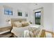 Bright bedroom featuring a comfortable bed, lots of natural light from large windows, and modern decor at 20649 E Vallejo Ct, Queen Creek, AZ 85142