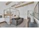 Bright bedroom with hardwood floors, four-poster bed, and a cozy sitting area for a relaxing retreat at 20649 E Vallejo Ct, Queen Creek, AZ 85142