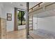 A bright bedroom boasts a custom bunk bed, natural light, and warm wood floors at 20649 E Vallejo Ct, Queen Creek, AZ 85142